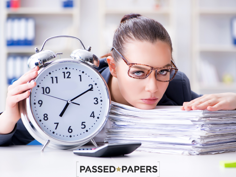 Woman with clock and pile of papers time management skills