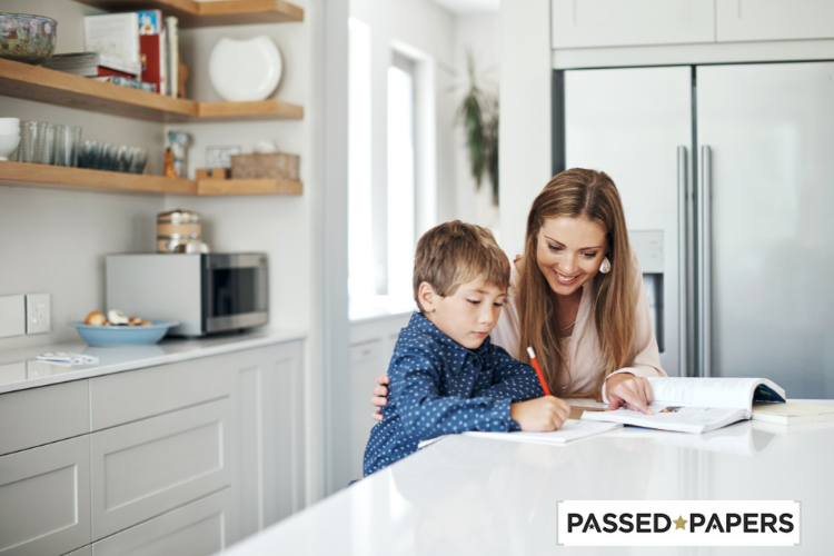 Mom helping boy at kitchen with MAP practice test guide for parents