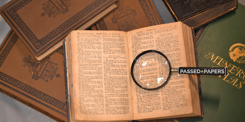 Old books with magnifying glass. Are grammar schools better?